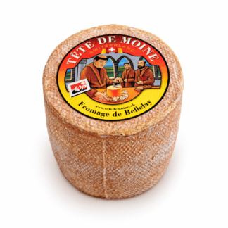 Whole wheel of Tête de Moine AOP Swiss cheese with its traditional Fromage de Bellelay label.
