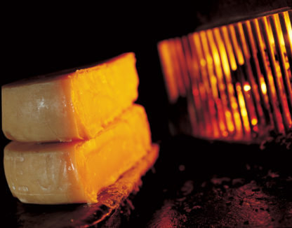 Traditional Swiss raclette over the open fire