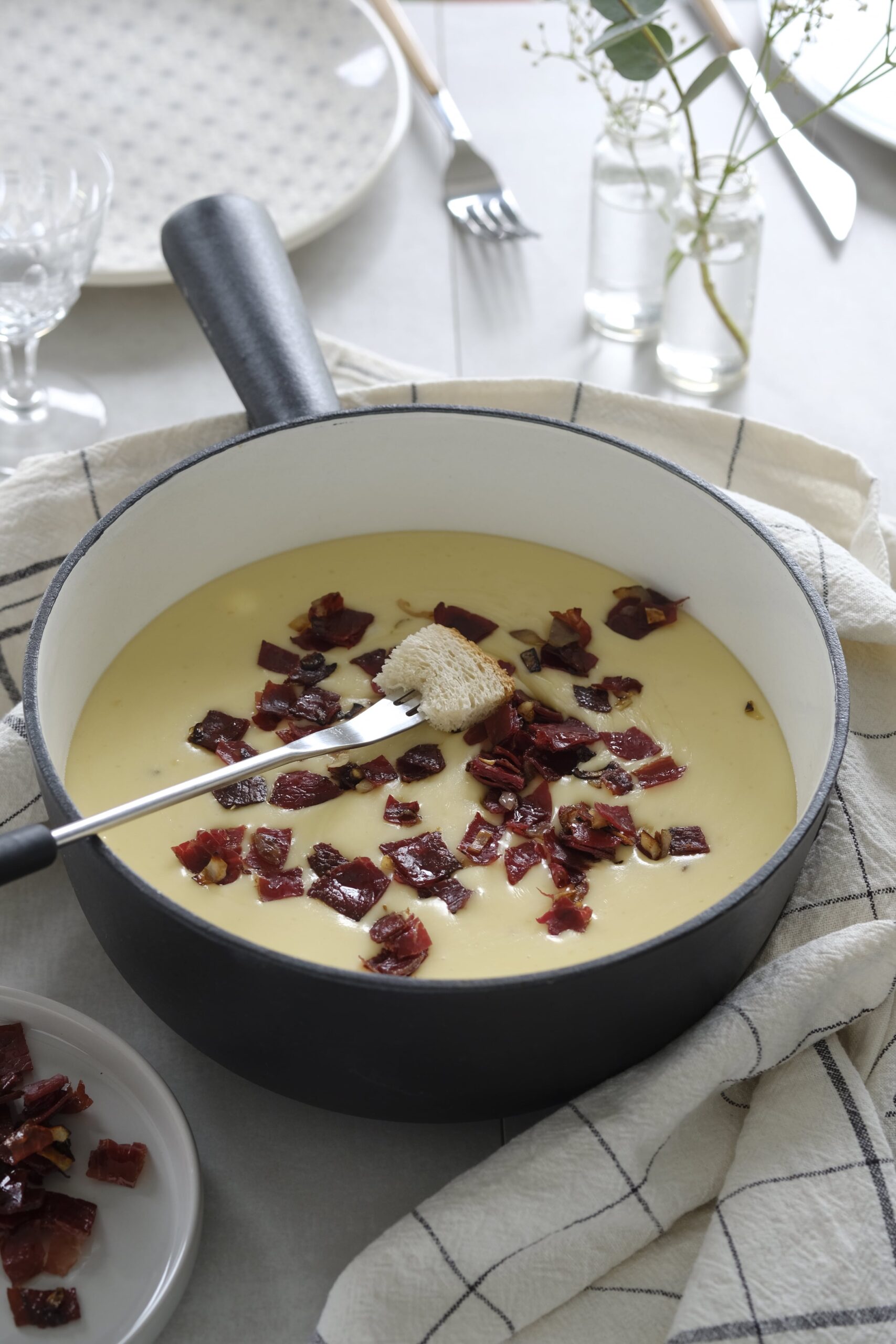 Cheese fondue topped with dried meat